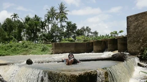 Calm indian man lying in the river Stock Footage 59823327