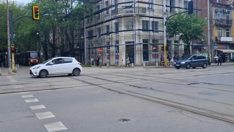 Calm intersection street view in central Sofia, Bulgaria, where cars and a tram 스톡 동영상 324404894