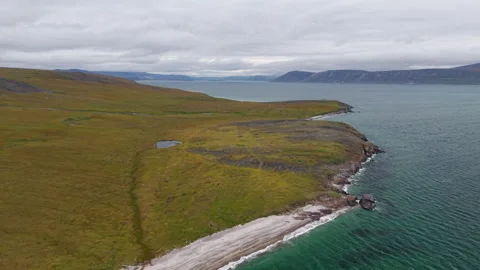 Calm lagoon and white surf along rocky peninsula of Lavrentiya Bay, Russia Stock Footage 327125468