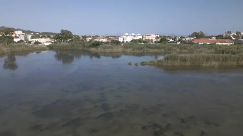 Calm Lagoon Water Reflection and Town Backdrop, Maristany, Mallorca Stock Footage 340589392