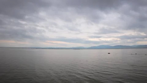 Calm Lake with Cloudy Sky and Mountain View Stock Footage 311962728