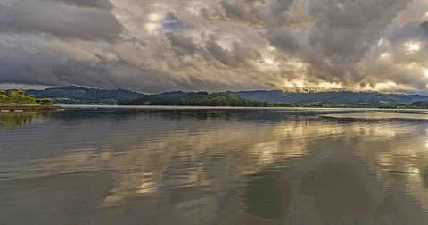 Calm Lake with Dramatic Cloud Reflections Stock Photos