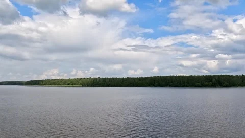 Calm lake with forest under cloudy sky. Stock Footage 341790860