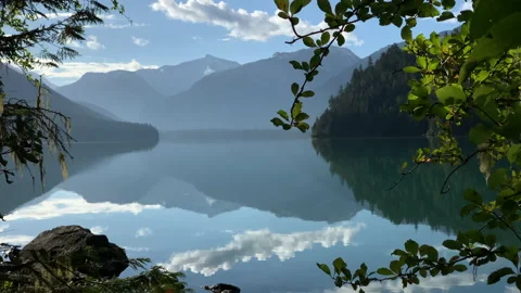 Calm lake, mountains in background, reflection of clouds in water Stock Footage 146820280