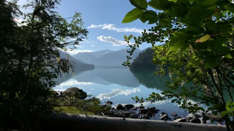 Calm lake, mountains in background, reflection of clouds in water Stock Footage 146820284