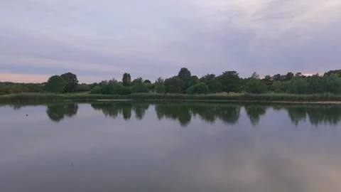Calm Lake Reflection At Dusk in Wicksteed Park Kettering Stock Footage 338331251