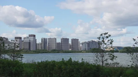 Calm lake reflects distant bustling megapolis skyline Stock Footage 327804415