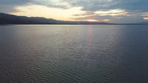Calm Lake at Sunset with Distant Hills Stock Footage 332890282