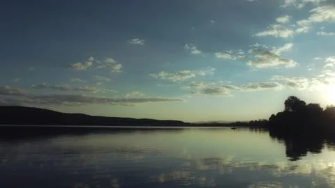 Calm lake at sunset Stock Photos