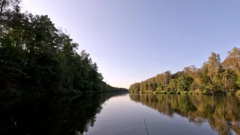 A calm lake with trees in the background Stock Footage 323178280