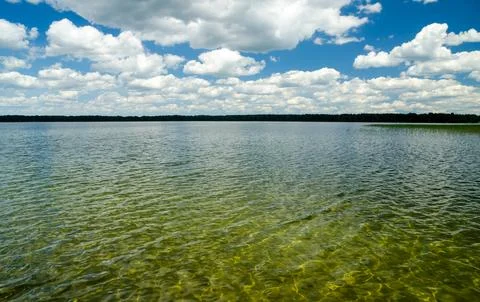 Calm lake under dramatic cloudy summer sky Фото