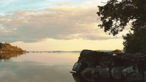 Calm lakeshore at sunset Video stock 93800176