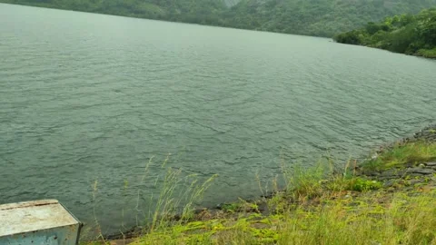 Calm Lakeside View at Aliyar Dam Reservoir, Tamil Nadu, India, with Grass a.. Stock Footage 320822000