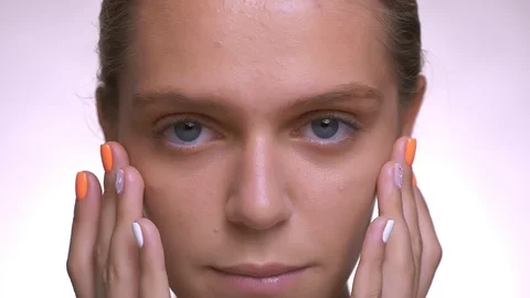 Calm look at camera and smooth touch of healthy fresh face by caucasian woman Video stock 96150842