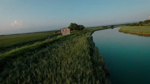 Calm low flight over field and river with the last light of the sunset FPV Drone Stock Footage 159864813
