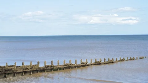 A calm low tide at a sandy beach in England during a hot summer Stock Footage 113826040