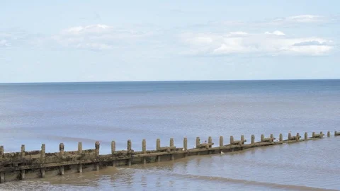 A calm low tide at a sandy beach in England during a hot summer Stock Footage 113827947
