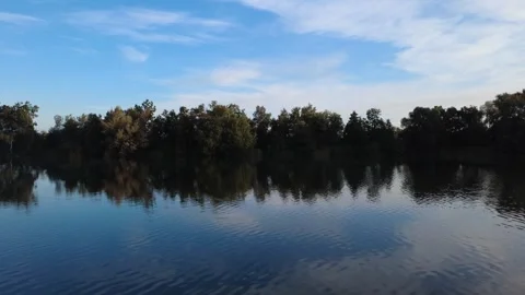 Calm Morning Drone Flight Over Lake with Water Reflections Stock Footage 328523625