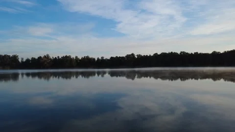 Calm Morning Drone Flight Over Lake with Water Reflections Stock Footage 328523634