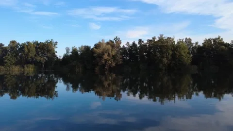 Calm Morning Drone Flight Over Lake with Water Reflections Stock Footage 328523660