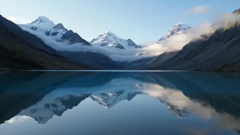 Calm Mountain Lake with Low Clouds and Reflections Stock Footage 314805452