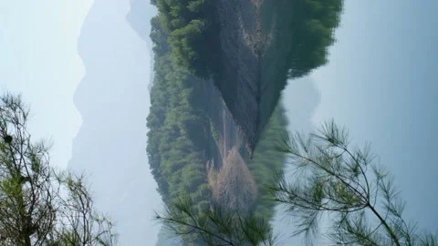 Calm mountain lake. Panoramic view of landscape and reflections. Vertical video. 動画素材 228828849