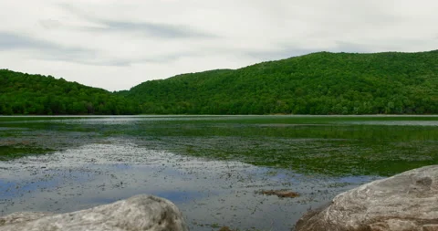 Calm mountain lake view in cloudy day Stock Footage 130969343