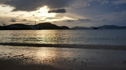 Calm moving sea wave hit sandy beach  coastline , silhouette mountain cloudy  Stock Footage 99480107
