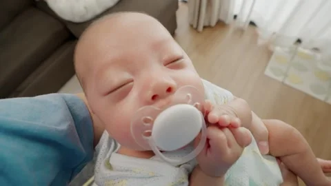 Calm newborn sleeps with pacifier 库存影片 340312181
