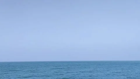 Calm ocean with a clear blue sky horizon view nature Stock Footage 322096104