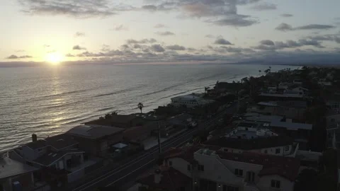 The calm ocean on the coast of a small beach town at sunset from drone Stockbeeldmateriaal 167677063