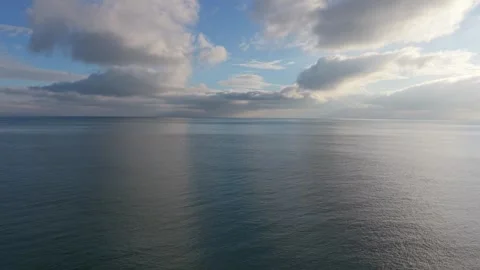 Calm Ocean Horizon with Clouds and Reflections Aerial Drone View Stock Footage 327840435