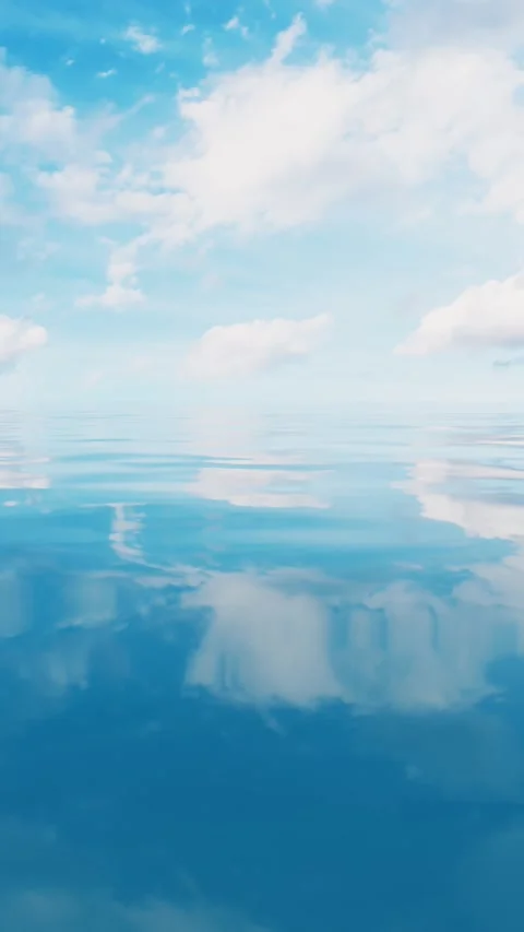 Calm ocean reflecting bright sky with soft clouds on sunny day Stock Footage 327342904
