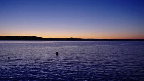 Calm Ocean Scene with Distant Land and Blue Twilight, 120fps Видео 310518532