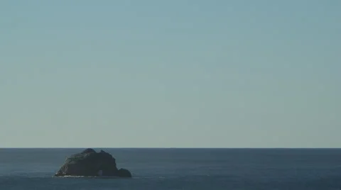 CALM OCEAN SCENE WITH SOLO ROCK AND NEGATIVE SPACE Stock Footage 59071329
