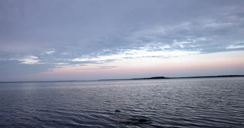 Calm ocean with skipping rocks causing ripples - wide shot Stock Footage 268163854