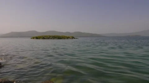 Calm Ocean with a Small Island Stock Footage 53202936