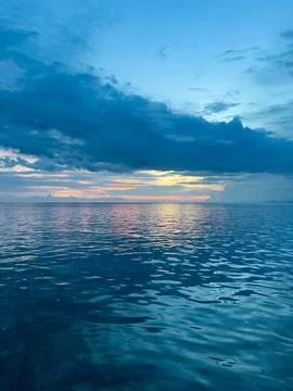 Calm Ocean at Sunset with Clouds Fotos de archivo