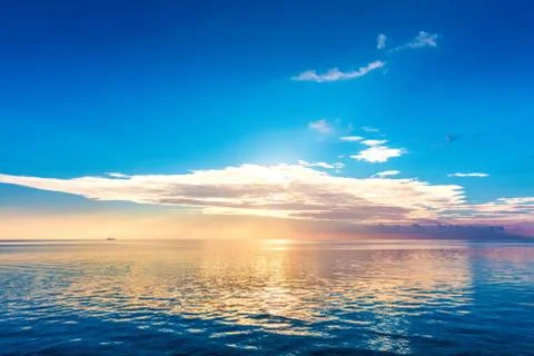 Calm ocean at sunset. Dramatic sky Stock Photos