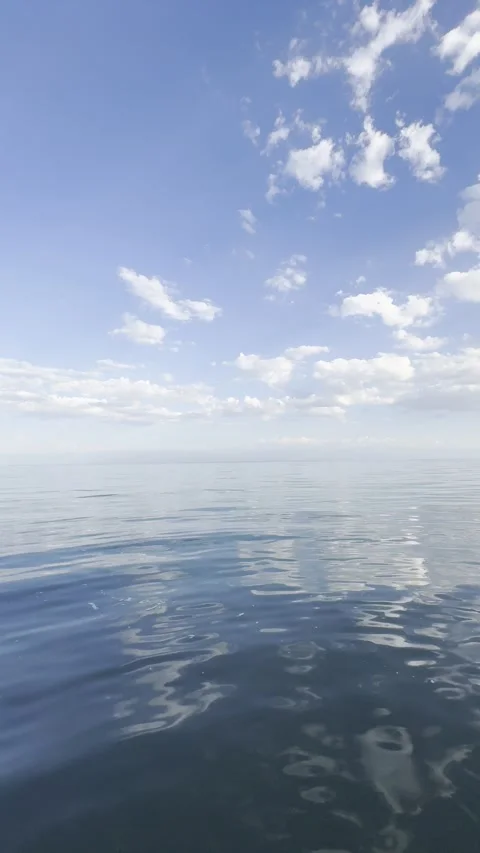 Calm Ocean Surface with Gentle Ripples Under Blue Sky Stock Footage 339564716