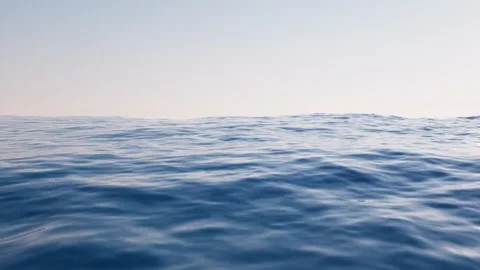 Calm ocean surface with gentle waves under a clear sky Stock Footage 327249592