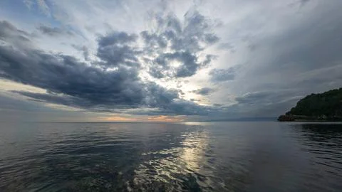 Calm Ocean Under Cloudy Sky at Sunset Stock Photos