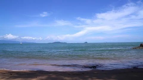 Calm ocean view with blue sky and distant islands Stock Photos