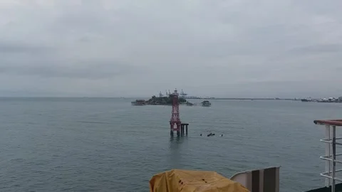 Calm ocean view from a moving ship deck with a navigation beacon in Indonesia Stock Footage 345974876