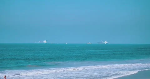 Calm ocean view with ships and sandy beach 스톡 동영상 339519890