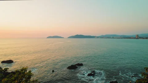 Calm ocean view at sunset with distant coastline and Jaco city in Costa Rica Video stock 342771759