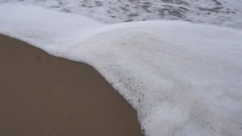 Calm ocean water waves splashing sandy beach Stock Footage 228458839
