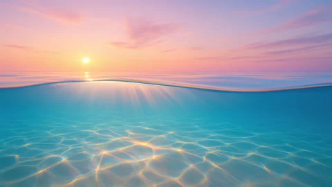 Calm Ocean Wave Loop with Sunrise Reflection Stock Footage 320147926