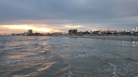 Calm ocean waves with buildings in the background Stock Footage 253718003