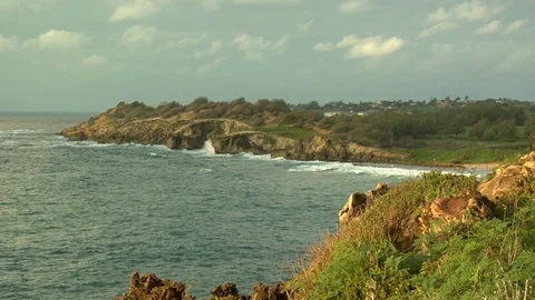Calm ocean waves crash onto cliff rocks A Stock Footage 125332264